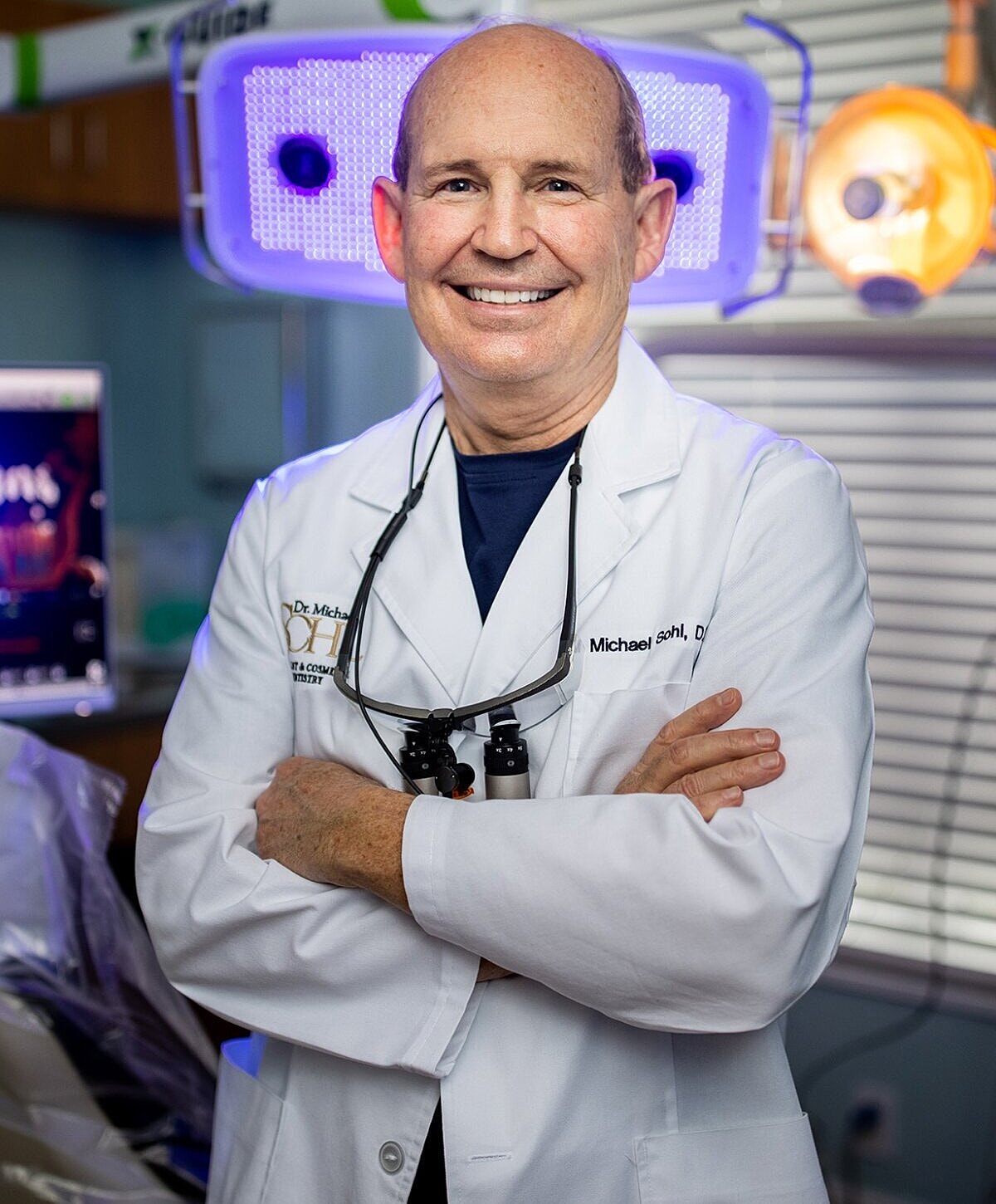 Smiling doctor in a dental clinic setting.