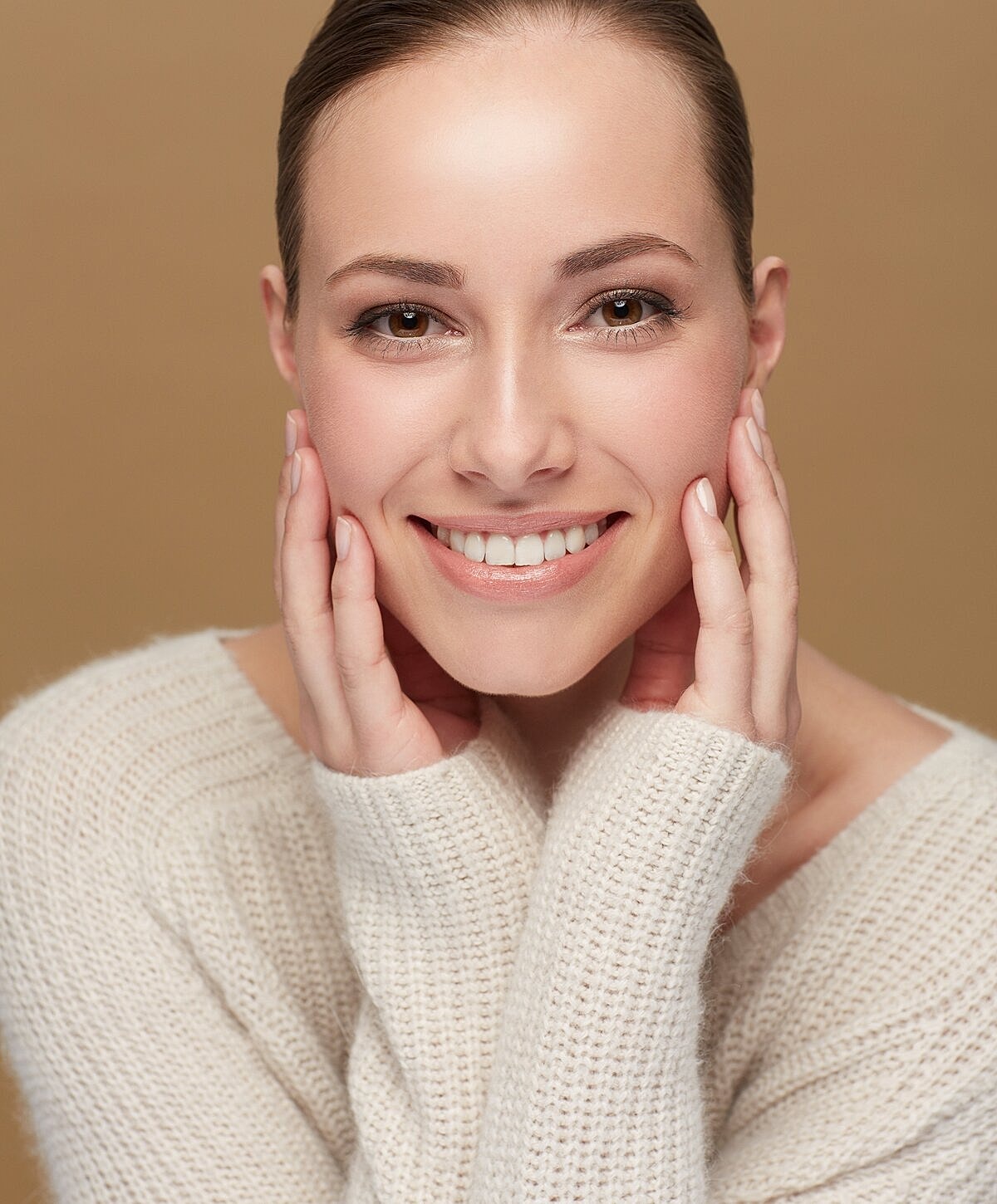 Smiling woman wearing a cozy sweater.