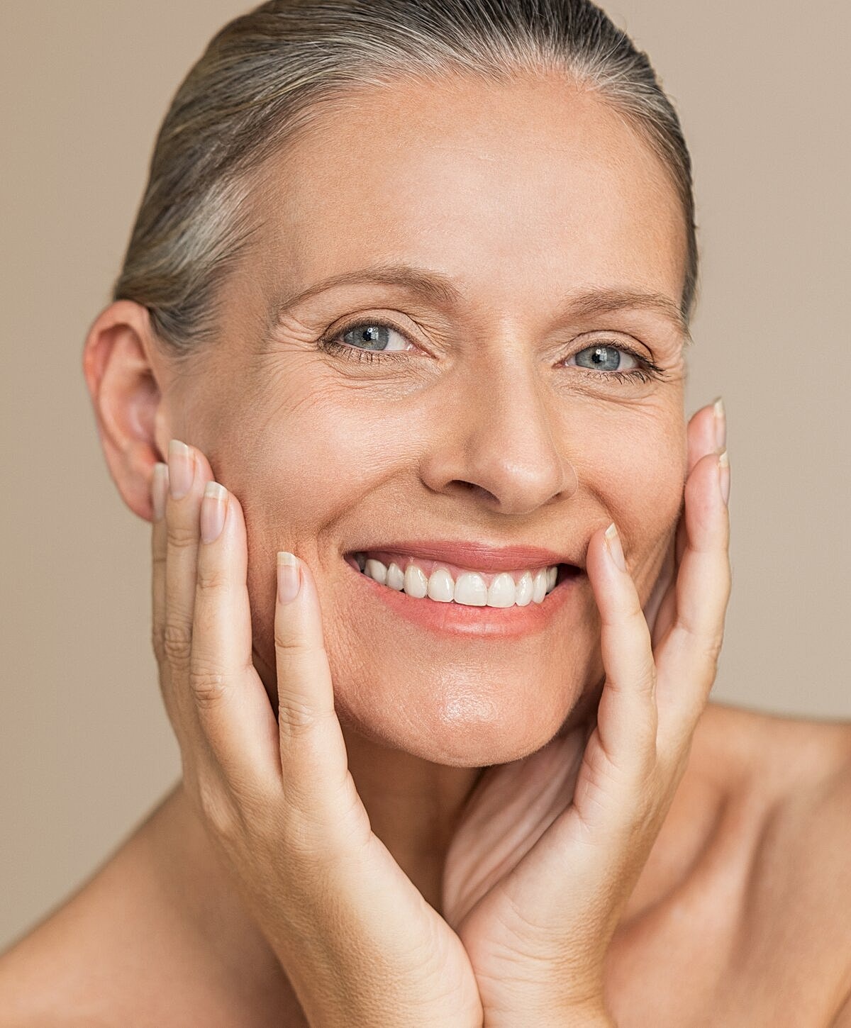 Smiling woman in white shirt outdoors.