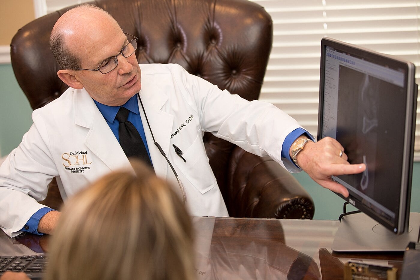 Dentist discussing X-ray with a patient.