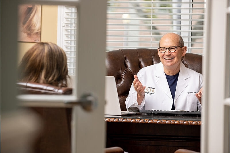 Doctor consulting with a patient in his office.