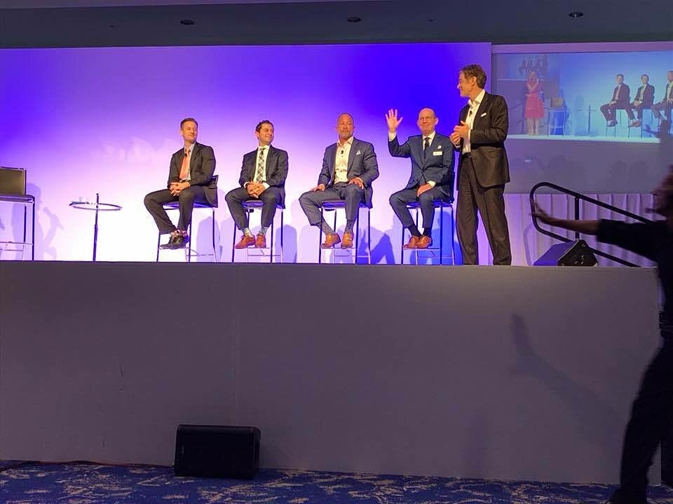 Panel discussion on stage with speakers.