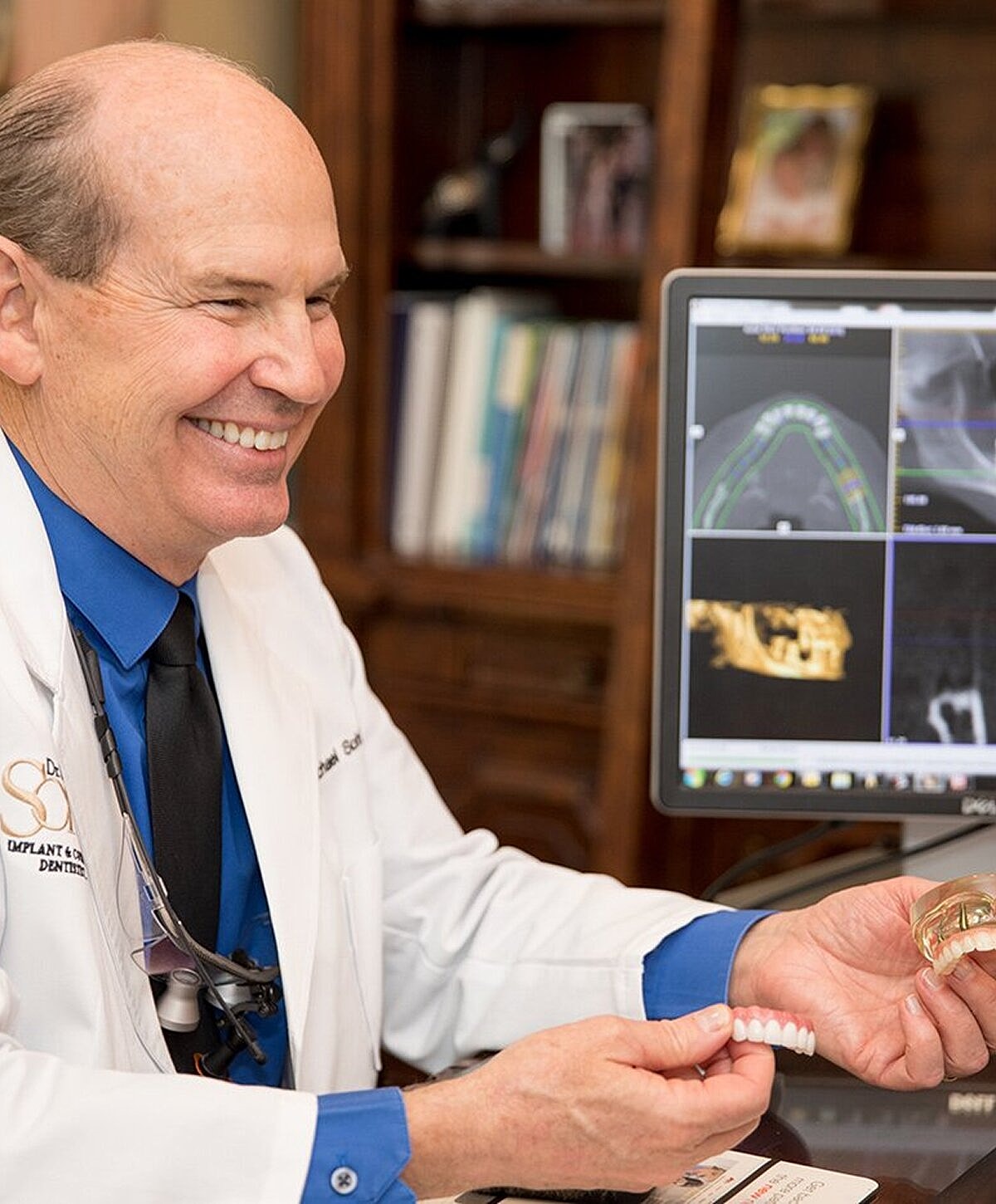 Smiling doctor in a dental office setting.