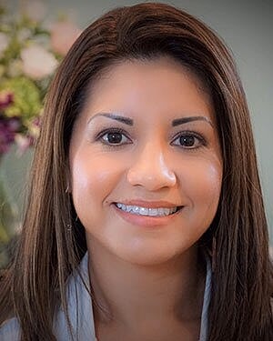 Smiling woman with long, straight hair.
