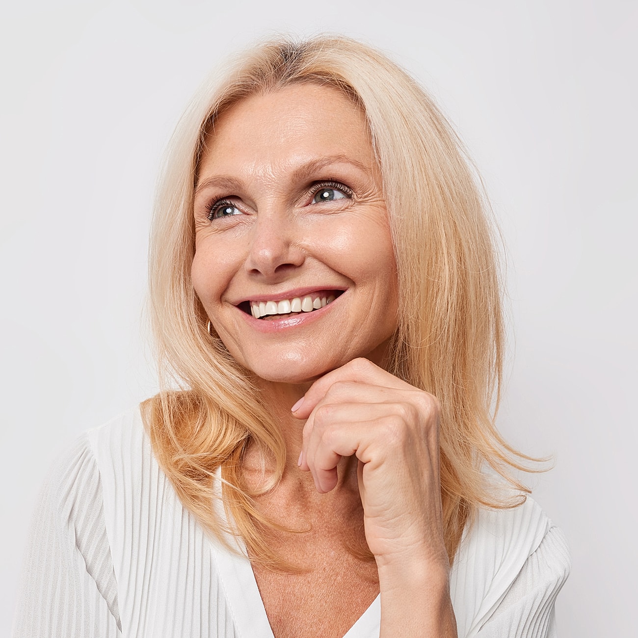 Smiling woman with long blonde hair.