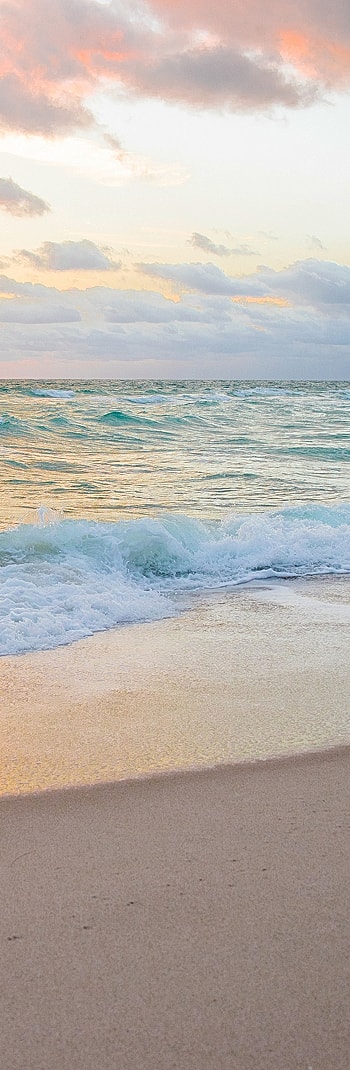 Gentle waves lapping on a sandy beach.