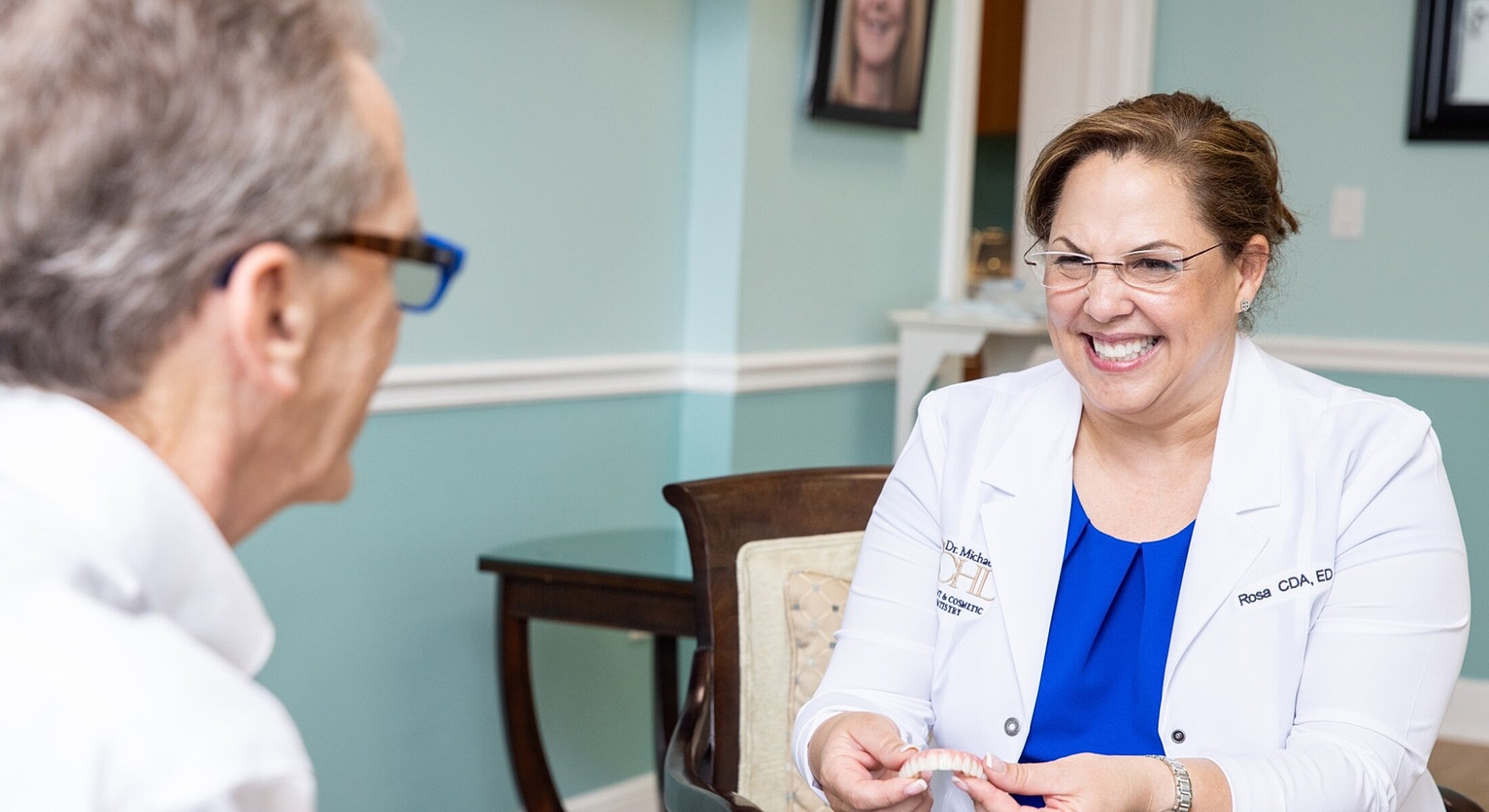 Dental consultation with smiling professionals in office.