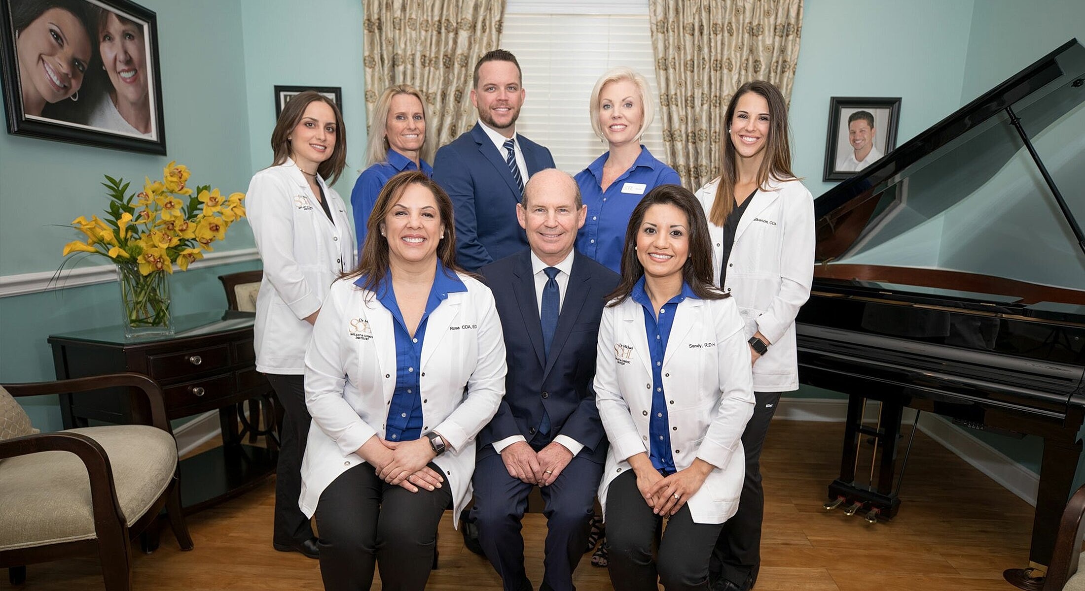 Dental team posing in an office setting.